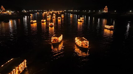 Traditional illuminated boats adorned with glowing marigold flowers gently floating on tranquil water during a vibrant cultural festival at night