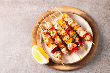 Grilled chicken skewers. Satay with side lemon and salad. Kebab with sauces. 