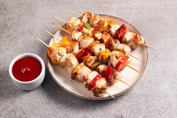 Grilled chicken skewers. Satay with side lemon and salad. Kebab with sauces. 