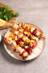 Grilled chicken skewers. Satay with side lemon and salad. Kebab with sauces. 