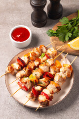 Grilled chicken skewers. Satay with side lemon and salad. Kebab with sauces. 
