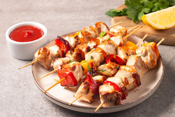 Grilled chicken skewers. Satay with side lemon and salad. Kebab with sauces. 