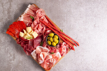 Charcuterie board. Antipasti appetizers of meat and cheese platter with salami, prosciutto crudo or jamon and olives