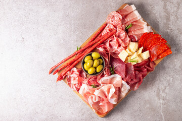 Charcuterie board. Antipasti appetizers of meat and cheese platter with salami, prosciutto crudo or jamon and olives