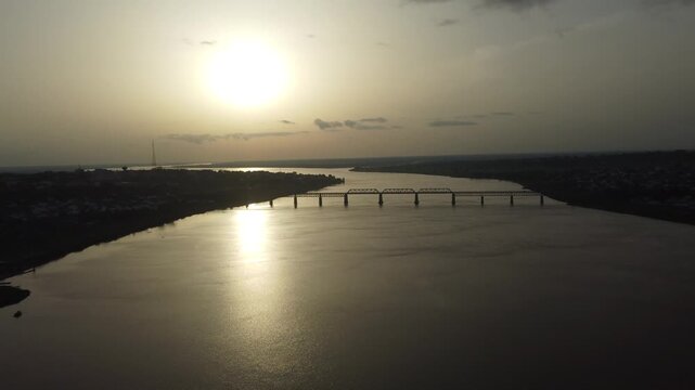 Aerial view of the bridge over the Benue River, reflecting the sunlight in a mesmerizing pattern over the water, Makurdi, Benue, Nigeria.