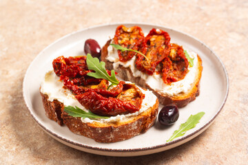 Toast with cream cheese and dried tomatoes. Open sandwich with arugula, bread, tomatoes, olives and oil. 