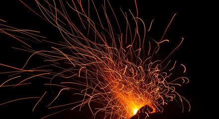 Dynamic Fiery Sparks on Black Background.