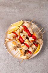 Grilled chicken skewers. Satay with side lemon and salad. Kebab with sauces. 