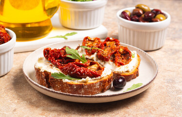 Toast with cream cheese and dried tomatoes. Open sandwich with arugula, bread, tomatoes, olives and oil. 