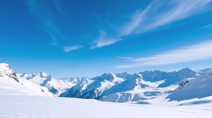 Snow-capped mountain peaks under a brilliant blue sky, with soft clouds drifting above the pristine white landscape, evoking serenity and grandeur.