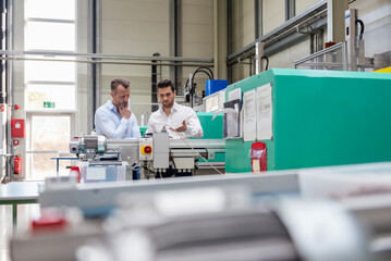 Business meeting and collaboration in modern production facility