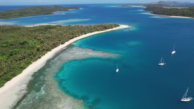 Beautiful aerial video of a wonderful blue and clear lagoon in Fiji. Islands views from the sky, white sand and boats. Location Yasawa islands in Fiji. 