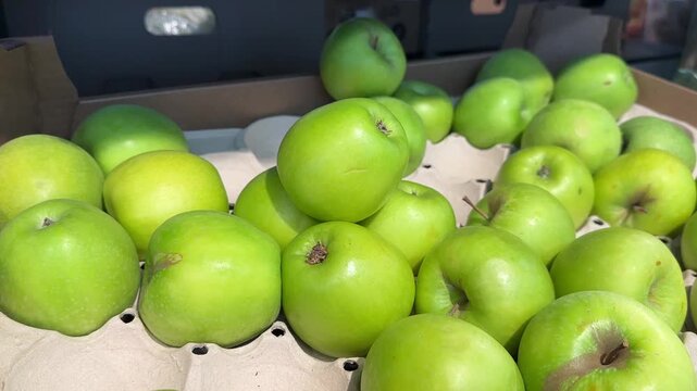 Green apples in box at the market