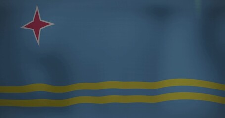 Displaying Aruba flag showing red four-pointed star outlined in white and two yellow bands