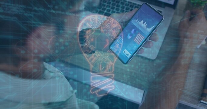 IT worker holding smartphone viewing data charts at desk, with laptop digital overlay, copy space