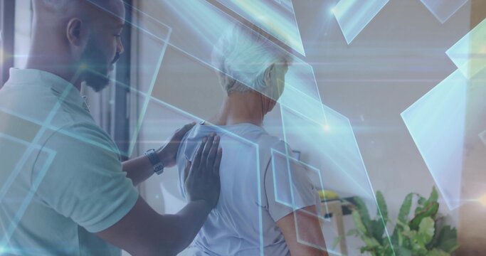 Guiding therapist placing hands on senior patient shoulders in therapy room, with digital overlays - Powered by Adobe