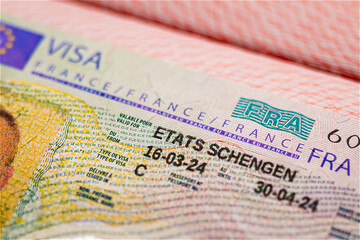 Schengen visa of France in passport, approved visit France and Europe. close-up