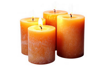 Four illuminated orange pillar candles with textured surfaces on black background flame fire
