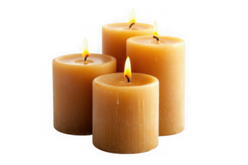 Four lit pillar candles in warm amber tones against a black background lit candle flame