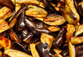 A pile of cooked vegetables including eggplant and peppers