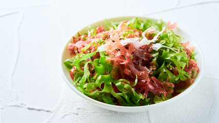 closeup mix kaiso seaweed salad green red white algae kelp in bowl on bright food background with copy space