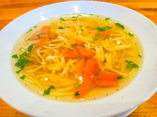 Traditional Polish broth in white bowl.