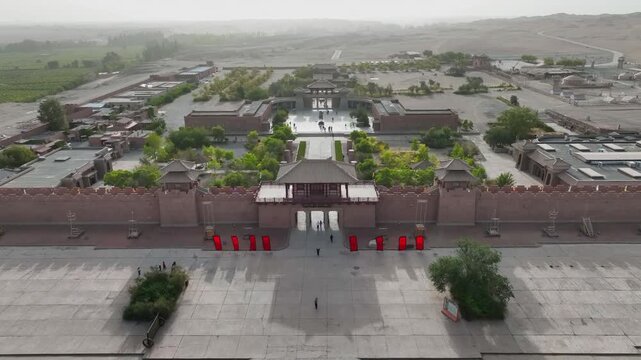 Aerial view of the historic Yangguan fortress, its walls and courtyards contrasting with the surrounding desert landscape, Yangguan, Gansu, China.
