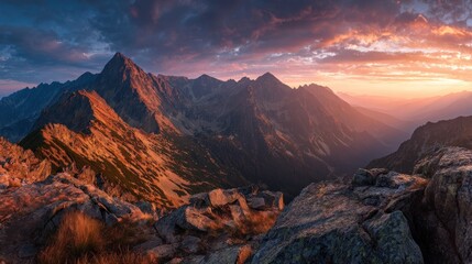 Majestic mountain range at sunset with vibrant sky and rocky foreground