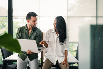 Busy smiling executive business team using digital devices in office. Diverse professional people