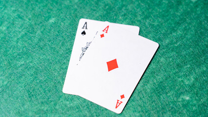 Two playing cards with the Ace of Spades and the Ace of Hearts on top of each other