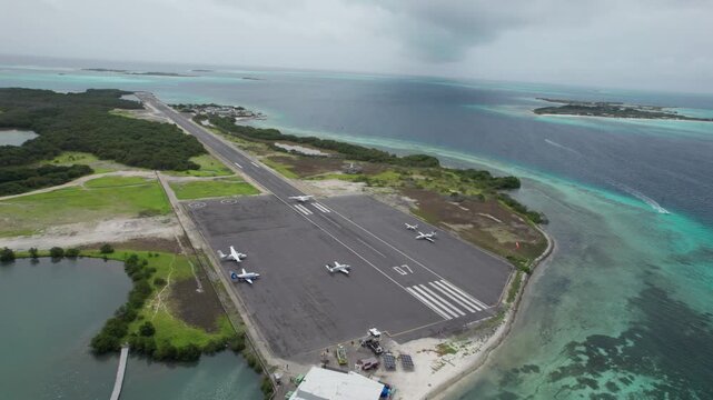 Aerial view of Los Roques airport as a plane lands on runway