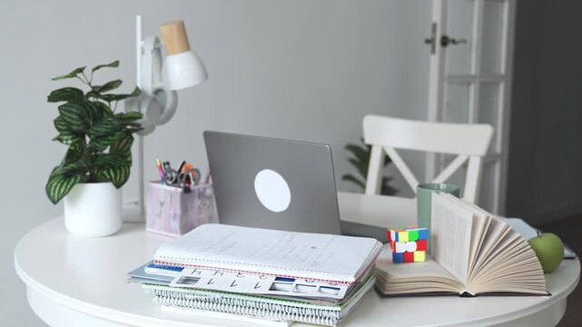 Desk table workspace for student or pupil for school or college. Educational stuff for child, online lessons at home, remote course, homework for child, schooling. White concept with copy space