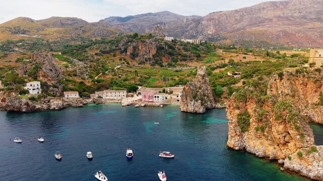 Rock Towers Of Faraglioni di Scopello In Castellammare del Golfo In Trapani, Italy. Aerial Drone Shot