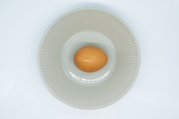 Boiled eggs in a circular bowl on a white background
