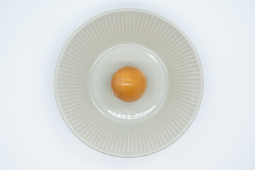 Boiled eggs in a circular bowl on a white background