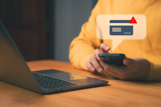 Credit card alert notification concept showing person holding smartphone with warning message, symbolizing online payment error, digital banking security risk, and financial fraud prevention.