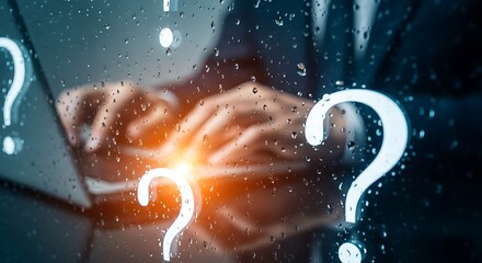 Businessman typing on laptop surrounded by glowing question marks and raindrops