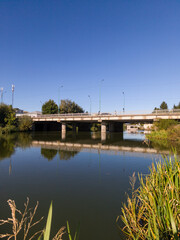 A bridge over a body of water with a blue sky in the background