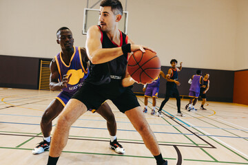 Fototapeta premium Basketball game with young male players