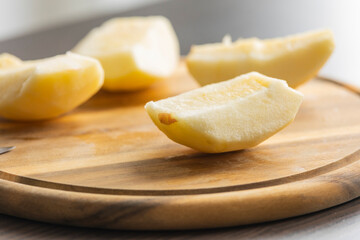 fresh crispy apple slice on wooden cutting board close up
