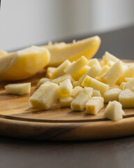 chopping fresh crisp apple on wooden cutting board close up
