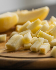 chopping fresh crisp apple on wooden cutting board close up