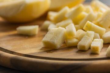 chopping fresh crisp apple on wooden cutting board close up