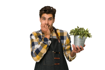 Young caucasian gardener man isolated on white background biting fingernails, nervous and very anxious.