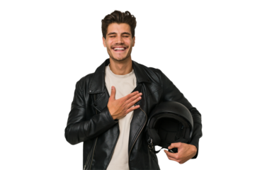 Young caucasian man holding a motrbike black helmet isolated laughs out loudly keeping hand on chest.