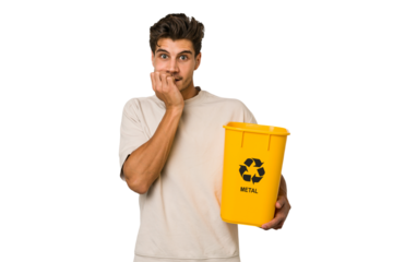 Young caucasian man holding a metal trash for recycle Young caucasian man holding recycling bins isolated on white background biting fingernails, nervous and very anxious.