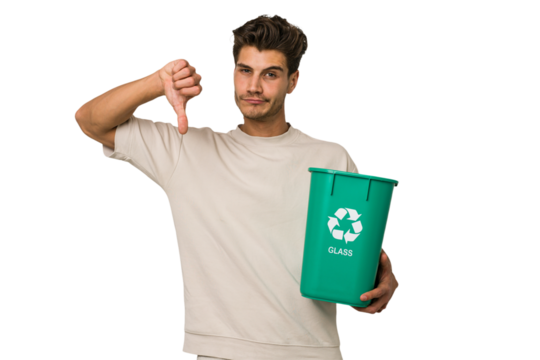 Young caucasian man holding a glass trash isolated showing a dislike gesture, thumbs down. Disagreement concept.