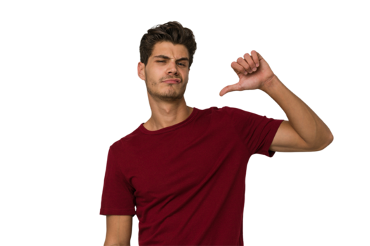 Young handsome caucasian man isolated on white background showing a dislike gesture, thumbs down. Disagreement concept.