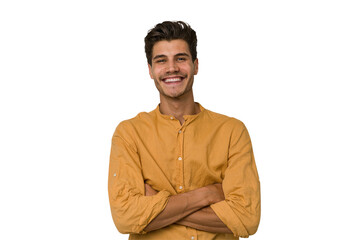 Young handsome caucasian man isolated on white background who feels confident, crossing arms with determination.