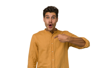 Young handsome caucasian man isolated on white background surprised pointing with finger, smiling broadly.